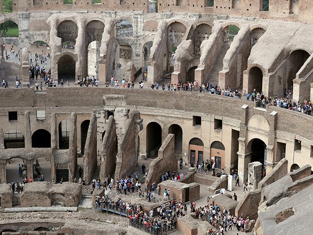 Tourists are seen visiting the ancient Colosseum as seen from the topmost floor on the occ