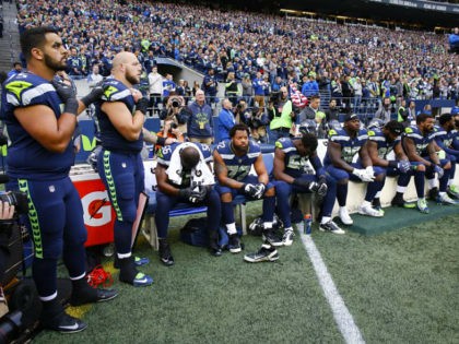 SEATTLE, WA - OCTOBER 1: Members of the Seahawks sit on the bench during the national anthem before the game against the Indianapolis Colts at CenturyLink Field on October 1, 2017 in Seattle, Washington. (Photo by Otto Greule Jr/Getty Images)