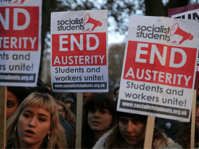 Demonstrators hold up placards at a protest march through central London on November 19, 2016 called by the National Union of Students and University College Union to demand free, quality further and higher education, accessible to all. / AFP / Daniel LEAL-OLIVAS (Photo credit should read DANIEL LEAL-OLIVAS/AFP/Getty Images)