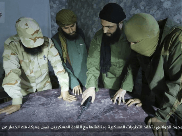 FILE -- This undated file photo, shows Abu Mohammed al-Golani, second right, then leader of Fatah al-Sham Front, in pictures posted by the group, discussing battlefield details with field commanders over a map, in Aleppo, Syria. Russia's military announced Wednesday, Oct. 4, 2017, that it carried out airstrikes in Syria …