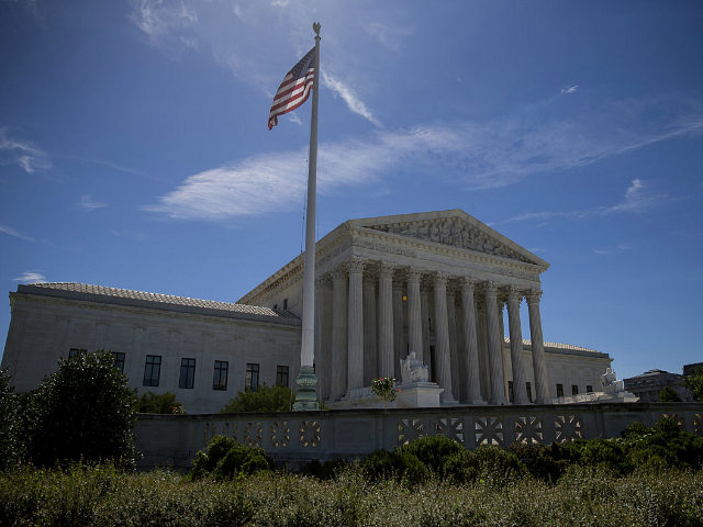 WASHINGTON, DC - JUNE 26: A flag flys outside the U.S. Supreme Court after it was announced that the court will allow a limited version of President Donald Trump's travel ban to take effect June 26, 2017 in Washington, DC. The Supreme Court will consider the case of the president's …