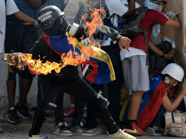 Opposition activists clash with the police during a demonstration marking 100 days of protests against Venezuelan President Nicolas Maduro in Caracas, on July 9, 2017. AFP/Federico Parra