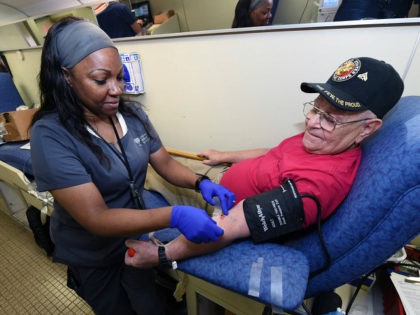 LAS VEGAS, NV - OCTOBER 02: United Blood Services phlebotomist Sha-Na Hill (L) takes blood from Richard Williams of Nevada at a special United Blood Services drive at a University Medical Center facility to help victims of a mass shooting on October 2, 2017 in Las Vegas, Nevada. A lone …