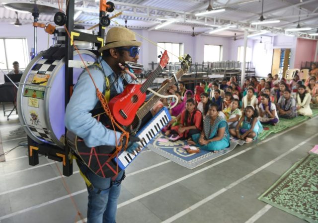 Indian one-man-band singer Gladson Peter performing in a church in Mumbai