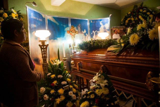 A woman stands next to the coffin of Stalin Sanchez Gonzalez, the slain mayor of Paracho,