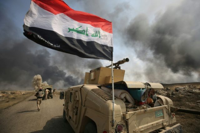 Iraqi forces and the Hashed al-Shaabi (Popular Mobilisation units) hold a position as they