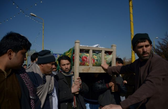 Mourners carry the coffin of one of the six Afghan employees of the Red Cross murdered in