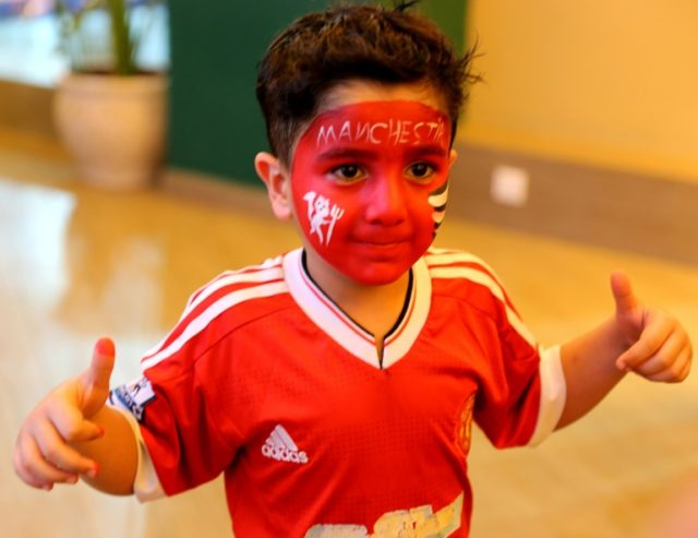 A young Iraqi Manchester United fan at a cafe in Baghdad. Supporting European teams offers