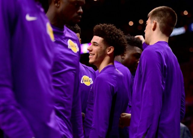 Lonzo Ball of the Los Angeles Lakers smiles from the sidelines during a timeout in the fir