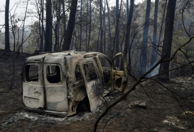 Two people died in a van trapped by flames near the town of Nigran, northwestern Spain, du