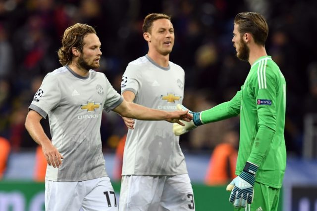 (From L) Manchester United's Daley Blind, Nemanja Matic and David De Gea celebrate after t