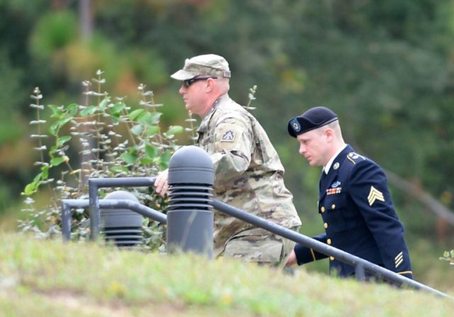 US Army Sgt. Bowe Bergdahl (R) is escorted to a military courthouse for a hearing on Octob