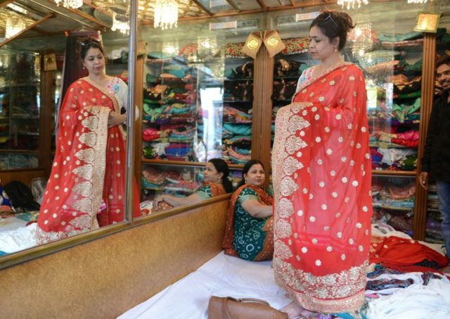 A woman looks at sarees in a store in the Indian city of Hyderabad