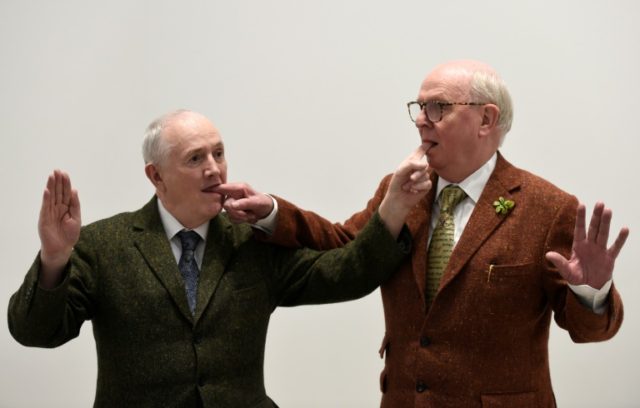 Artists Gilbert & George pose prior to their exhibition "The Beard Pictures" at the Th