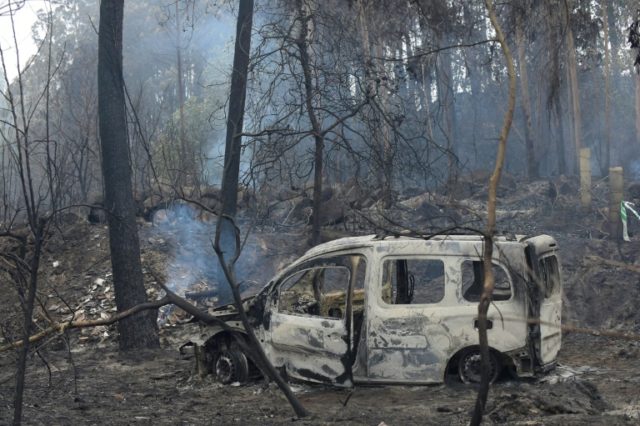 The wreckage of a burned van in which two people died trapped by flames