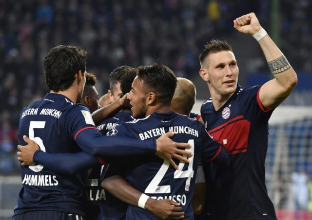 Bayern Munich's Corentin Tolisso (front) celebrates scoring with teammates during their ma