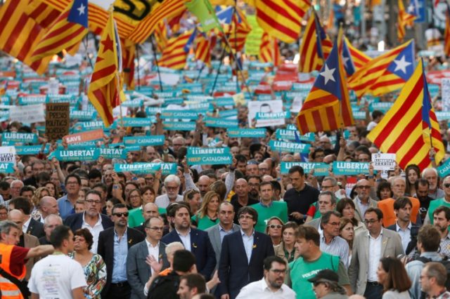 ​Catalan leaders including regional president Carles Puigdemont join a rally in Barcelon