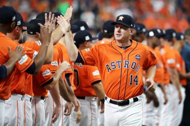 The Houston Astros manager A.J. Hinch high-fives his players prior to game one of the Amer