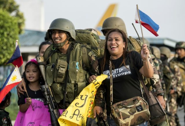 Philippine soldiers greeted by relatives as they returned from Marawi's frontlines on Frid