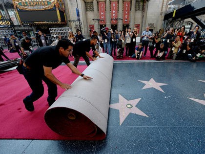 HOLLYWOOD, CA - FEBRUARY 18: Workers Rodolfo Morales (L) and Ernest Jauregui (R) roll out