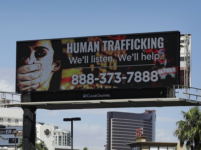 A billboard displays a phone number for the National Human Trafficking Hotline, Thursday, Sept. 21, 2017, in Las Vegas. The FBI in Las Vegas is teaming with a billboard company to raise the profile in the fight to stop human trafficking in a state where brothels are legal in rural counties, but prostitution is illegal in cities like Las Vegas and Reno. (AP Photo/John Locher)