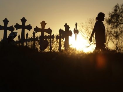 Miranda Hernandez pays her respects as she visits a makeshift memorial with crosses placed near the scene of a shooting at the First Baptist Church of Sutherland Springs, Monday, Nov. 6, 2017, in Sutherland Springs, Texas. A man opened fire inside the church in the small South Texas community on …