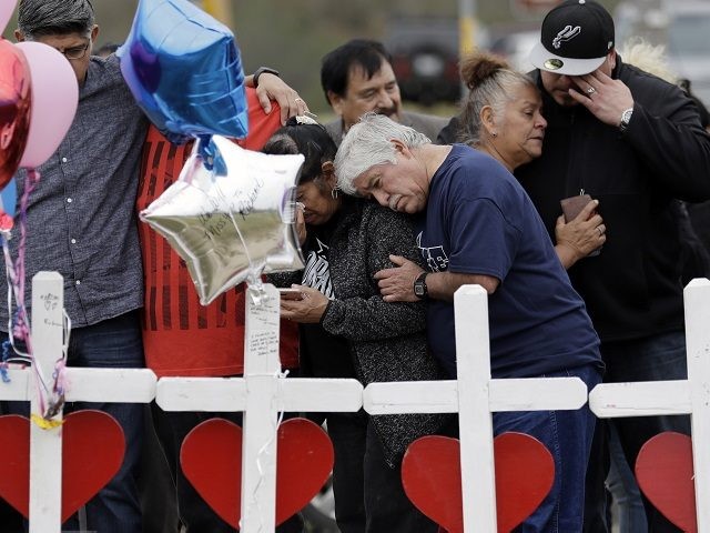 Family and friends gather around a makeshift memorial for the victims of the First Baptist Church shooting at Sutherland Springs Baptist Church, Friday, Nov. 10, 2017, in Sutherland Springs, Texas. A man opened fire inside the church in the small South Texas community on Sunday, killing more than two dozen. …