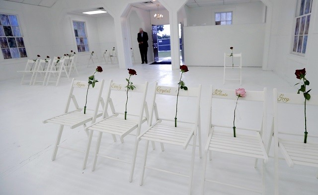 A memorial for the victims of the shooting at Sutherland Springs First Baptist Church, including 26 white chairs each painted with a cross and and rose, is displayed in the church Sunday, Nov. 12, 2017, in Sutherland Springs, Texas. A man opened fire inside the church in the small South Texas community last week, killing more than two dozen. (AP Photo/Eric Gay)