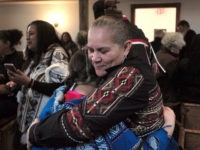 Jessie "Little Doe" Baird HOLD FOR STORY BY PHILIP MARCELO -- In this Saturday, Nov. 18, 2017 photo Jessie “Little Doe” Baird, front right, vice chairwoman of the Mashpee Wampanoag tribe, hugs a member of the audience following the "We Gather Together" celebration at the Old Indian Meeting House, in Mashpee, Mass. For more …