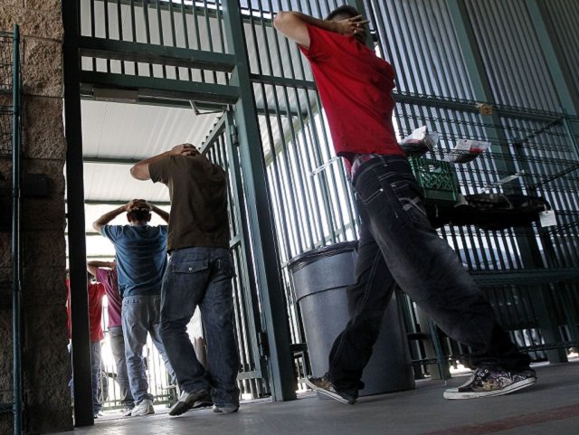 Illegal immigrants prepare to enter a bus after being processed at Tucson Sector U.S. Bord