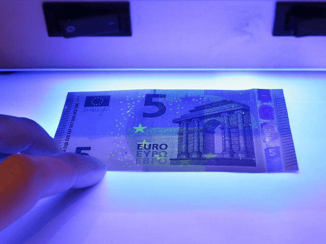 MAINZ, GERMANY - APRIL 26: The new 5 Euro note is displayed under a UV light at the German