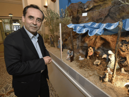 The mayor of Beziers, supported by the French far right Front national party (FN), Robert Menard, looks at a nativity scene displayed at the Beziers city hall on December 5, 2014. Menard wants to keep the Christmas creche installed in the town hall, despite of a letter of the Herault's …