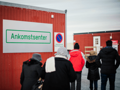 Refugees enter the arrival centre for refugees near the town on Kirkenes, northern Norway,