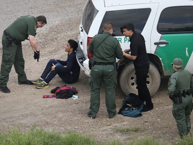 MCALLEN, TX - MARCH 15: U.S. Border Patrol agents detain two undocumented immigrants after capturing them near the U.S.-Mexico border on March 15, 2017 near McAllen, Texas. U.S. Customs and Border Protection announced that illegal crossings along the southwest border with Mexico dropped 40 percent during the month of February. …