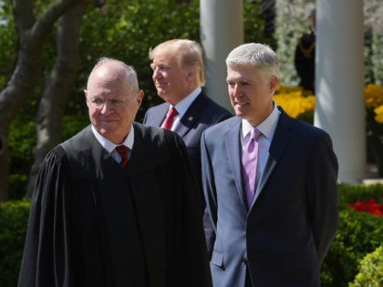(L-R) Justice Anthony Kennedy, US President Donald Trump, and Neil Gorsuch take part in Gorsuch's swearing-in ceremony as an associate justice of the US Supreme Court in the Rose Garden of the White House on April 10, 2017 in Washington, DC. / AFP PHOTO / MANDEL NGAN (Photo credit should …