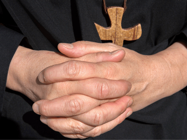 A nun's hands are pictured at the Saint-Vincent abbey in Chantelle on September 30, 2017. Sisters at the Saint-Vincent abbey in Chantelle, who employ some ten non-religious people, have been manufacturing beauty products since 1954 thanks to two of them, one a chemist and the other a mathematician. Body milk, …