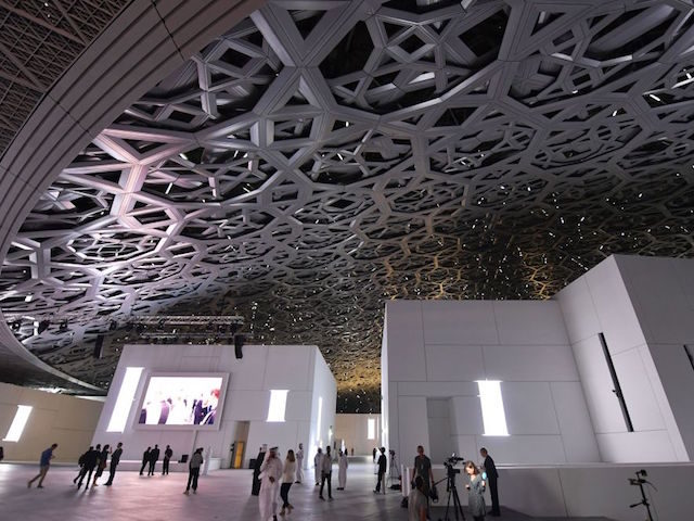 A general view shows people walking under the dome at the Louvre Abu Dhabi Museum that was