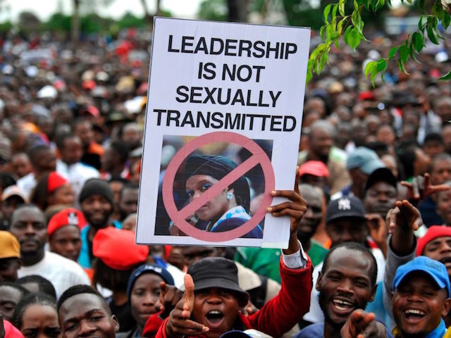 People hold an anti-Grace Mugabe placard during a demonstration demanding the resignation