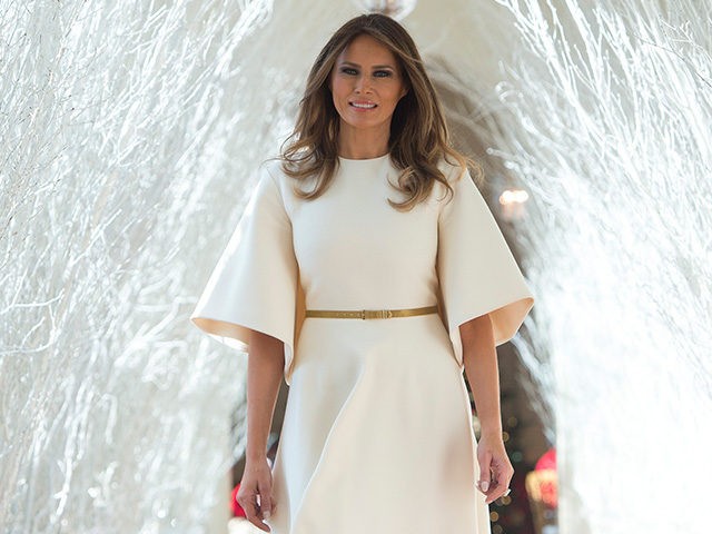 US First Lady Melania Trump walks through Christmas decorations in the East Wing as she to
