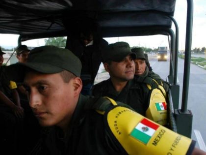 Mexican soldiers en route to the US border on 6 September 2005. The convoy was carrying wa