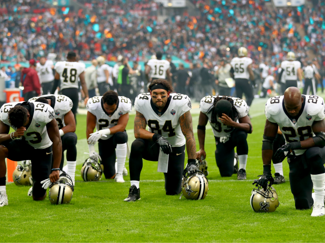LONDON, ENGLAND - OCTOBER 01: New Orleans Saints players and team kneel prior to the NFL match between New Orleans Saints and Miami Dolphins at Wembley Stadium on October 1, 2017 in London, England. (Photo by Clive Rose/Getty Images)