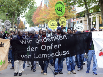 Refugees from Africa and supporters hold a banner reading 'We remember the vicitms of Lampedusa' as they participate in a demonstration on October 23, 2013 in Hamburg, Germany