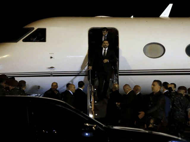 Lebanese Prime Minister Saad Hariri walks down the steps of an airplane upon arriving at t