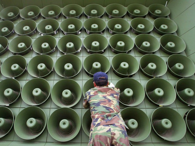 A South Korean soldier takes down a battery of propaganda loudspeakers on the border with