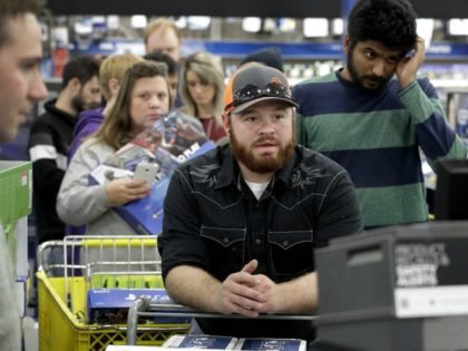 People line up to check out as they shop a Black Friday sale at a Best Buy store on Thanks