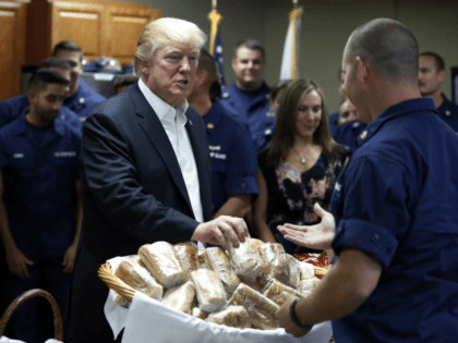 President Donald Trump hands out sandwiches to members of the U.S. Coast Guard at the Lake Worth Inlet Station, on Thanksgiving, Thursday, Nov. 23, 2017, in Riviera Beach, Fla. (AP Photo/Alex Brandon)