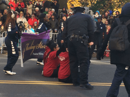 The protesters sat in the middle of Central Park West at 70th Street and momentarily delay