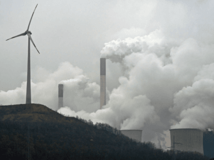 FILE - In this file photo dated Monday, Dec. 1, 2014, a wind turbine overlooks the coal-fired power station in Gelsenkirchen, Germany. A U.N.’s environment report Tuesday Oct. 31, 2017 says countries and industries need to do more to meet targets to trim emissions of greenhouse gases that experts say …