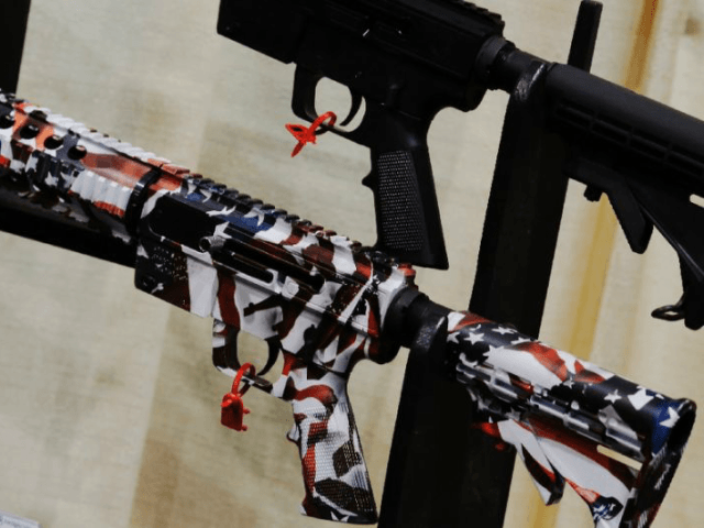 A gun with an American flag decoration at a trade show by the National Rifle Association,