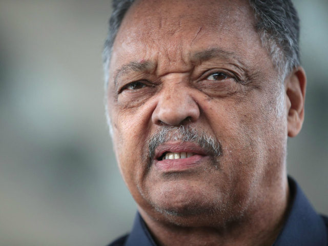 Civil rights leader Reverend Jesse Jackson leads a small group from the Rainbow PUSH Coali